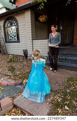 Denver, Colorado, USA-October 31, 2014. Trick or treating in costumes on Halloween night.