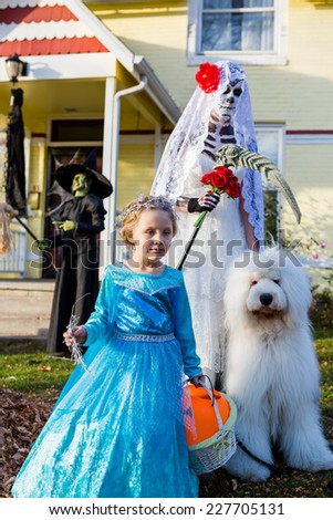 Trick or treating in costumes on Halloween night.