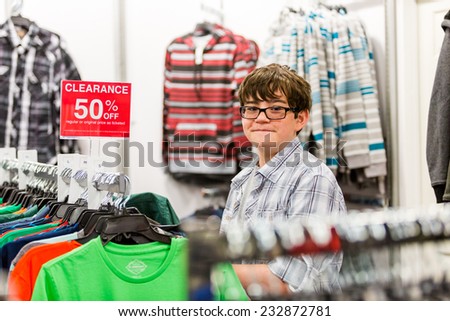 Teenager shopping for new clothes at the department stpre.