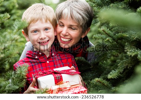 Family selecting a tree for Christmas at the Christmas tree farm.