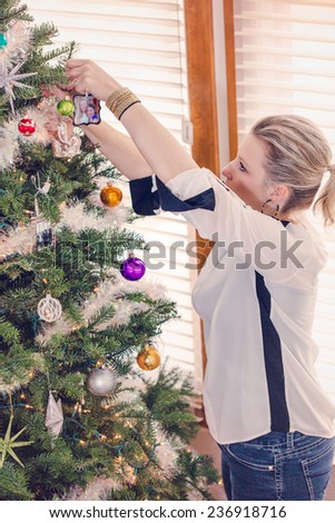 Family decorating beautiful live Christmas tree.
