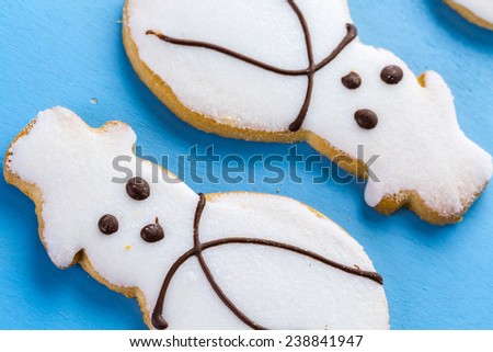Frosted white sugar cookies in shape of snowman.