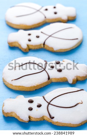 Frosted white sugar cookies in shape of snowman.