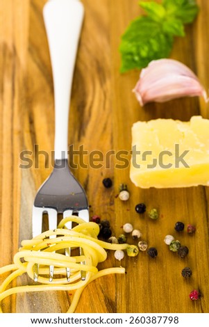 Ingredients for cheese and pepper pasta recipe on cutting board.
