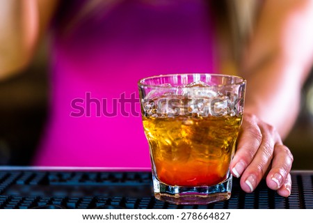 Bartender making new old fashioned cocktail in Italian restaurant.