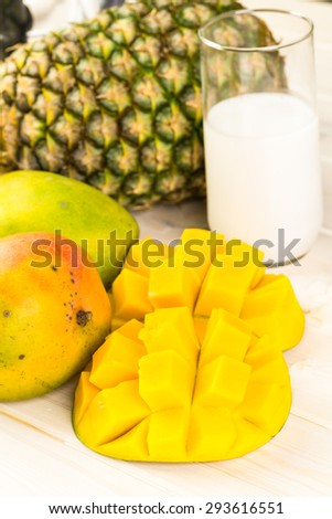 Fresh ingredients on the table to make smoothie with tropical fruits.