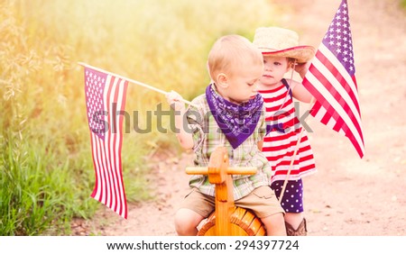 Toddlers having fun in the park for July Fourth.