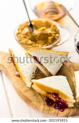 Homemade peanut butter and jelly sandwich on white bread.