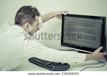 angry man grabbing his computer