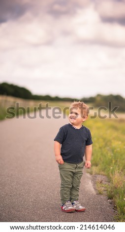 little kid standing and being happy in nature