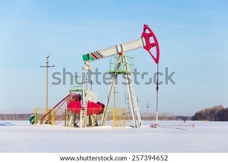Oil the machine on a snowy field on a Sunny day