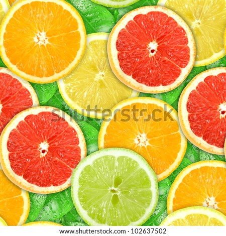 Abstract background with motley citrus-fruit slices and green leaf with dew. Seamless pattern for your design. Close-up. Studio photography.