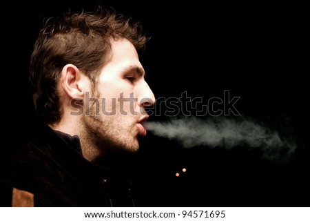 cigarettes are bad, nicotine is addictive handsome man breathing out cigarettes smoke