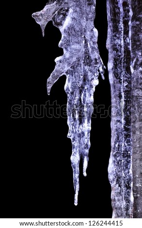 Beautiful blue icicle enlightened cold light in frost