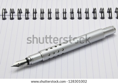 Metal ink pen and notepad with black spiral