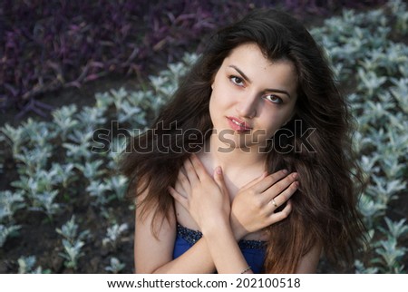 Beautiful oriental girl looks with hope and prayer on nature
