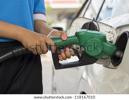 Woman worker refueling gasoline in gasoline station