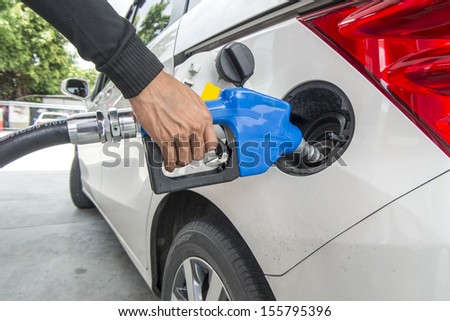 Car at gas station being filled with fuel