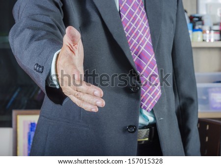A business man with an open hand ready to seal a deal