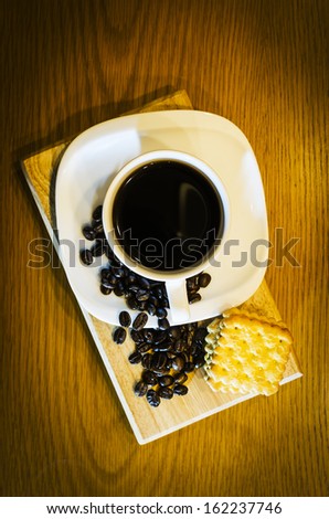 Coffee beans,coffee cup and crackers , Focus on coffee beans