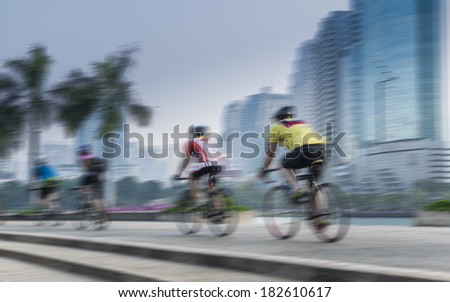 Motion blurred group of cyclist biking in the park