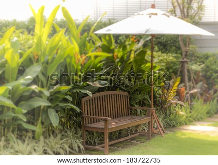 Relaxation corner with leisure chair and umbrella in the garden