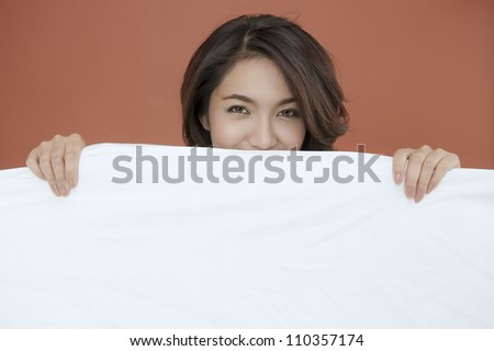 Portrait of eye smiling young beautiful lady behind Blanket