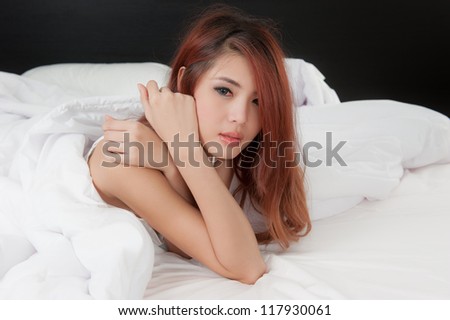 Crying woman on bed