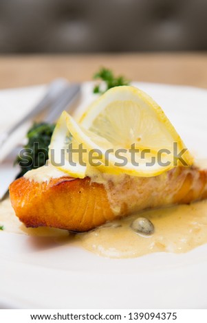Salmon steak with caper lemon sauce with mashed potato and spinach