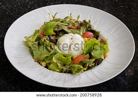 Started Salad with egg purse, lettuce, apple wood lardoons and cinnamon black pepper vinaigrette
