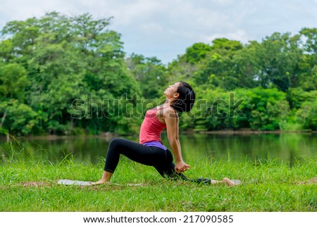 asian women practicing yoga in the garden background