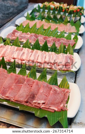 Fresh beef bacon and pork for sukiyaki in buffet line