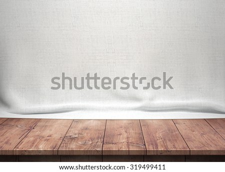 Wood table with white fabric background