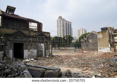 SHANGHAI - AUG 12: Modern skyscrapers rise behind a rubble site, the former houses of expropriated citizens. Picture taken on 12 AUG 2007