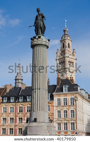 Statue of the French Revolution (built 1792), tower of the Chambre de Commerce and historical houses in the centre of Lille, France