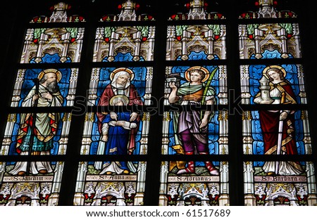 Stained glass church window in Church of Our Lady in Alsemberg, Belgium, made in 1895, depicting saints Joachim, Ana, Adrian and Barbara.