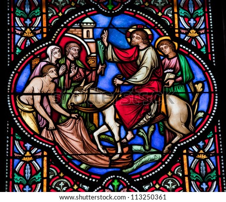 BRUSSELS - JULY 26: Stained glass window depicting Jesus entering Jerusalem on Palm Sunday, in the cathedral of Brussels on July, 26, 2012.