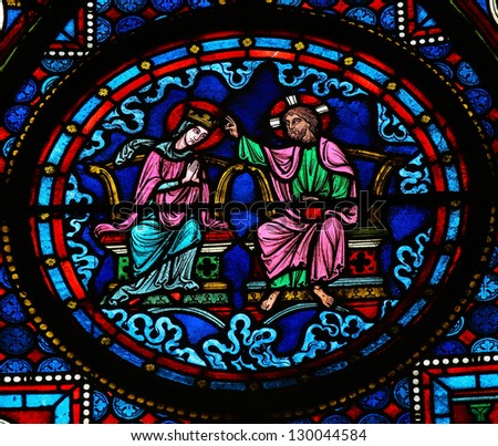 BAYEUX - FEBRUARY 12: Stained glass window depicting Jesus and Mother Mary in Heaven, in the cathedral of Bayeux, Normandy, France on February 12, 2013.