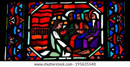 AMIENS, FRANCE - FEBRUARY 9, 2013: Stained glass window depicting Jesus washing the feet of the apostle Peter at the Last Supper on Maundy Thrusday, in the Cathedral of Our Lady of Amiens, France.