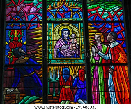 VIENNA, AUSTRIA - MAY 28, 2010: Stained glass window depicting the adoration of Mother Mary in the Votive Church in Vienna, Austria.