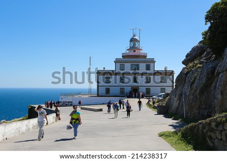 FISTERRA, SPAIN - JULY 29, 2014: Lighthouse at the End of the World at Cape Finisterre in Galicia, Spain. This site is a famous end destination for pilgrims on the Way of St. James.