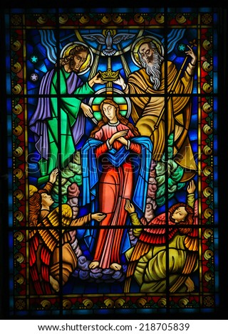 PONTE DE LIMA, PORTUGAL - AUGUST 3, 2014:  Stained glass window depicting Mother Mary and the Holy Trinity in Ponte de Lima, a town in the Northern Minho region in Portugal.