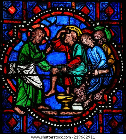 TOURS, FRANCE - AUGUST 8, 2014: Stained glass window depicting Jesus washing the feet of Saint Peter at the Last Supper on Maundy Thursday in the Cathedral of Tours, France.