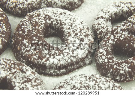 Dark chocolate biscuits with fine sugar on a white background