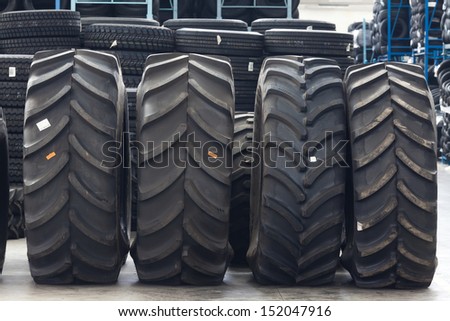 Big machines tires stack background. Industrial tires