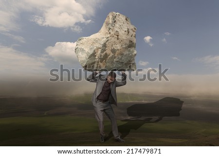 Businessman holding a boulder above his head. Challenge, difficult, problems concept