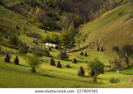 Picturesque valley with haystacks
