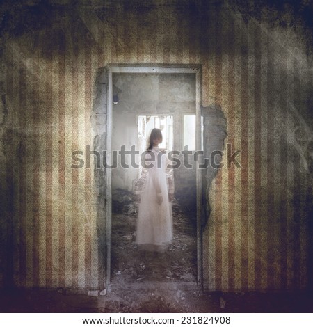 Ghost girl with twisted head in door frame in abandoned grunge building
