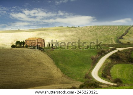 Tuscany landscape with a sunny property and fields