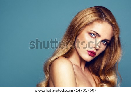 Close-Up Portrait Of Beautiful Model With Bright Lips. Shooted On Dark Turquoise Background